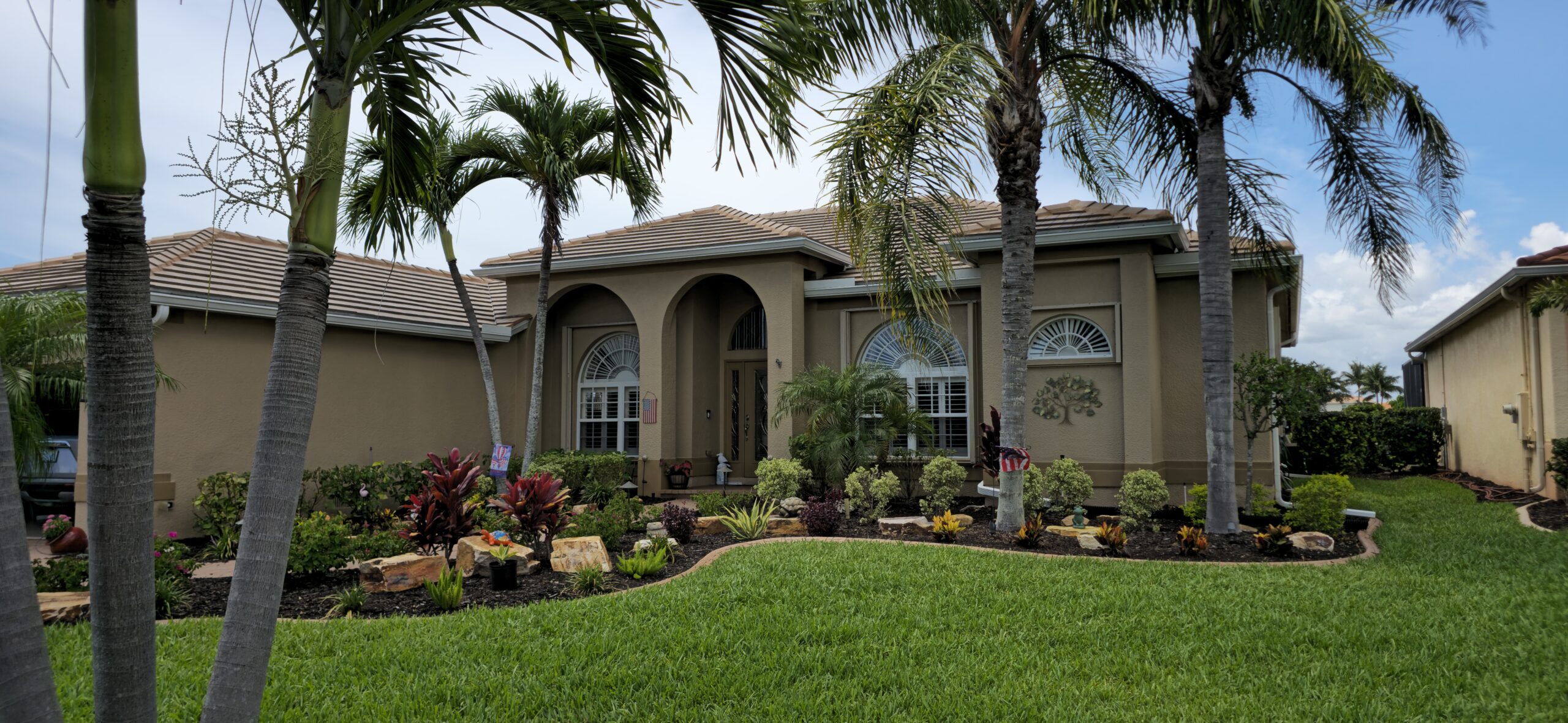 Technician performing trusted gutter repairs Naples FL on residential home